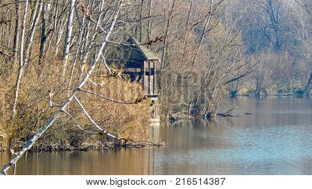 Wooden house on a water of a lake in autumn