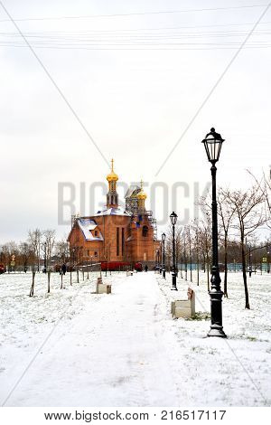 Park in Rybatskoe and the church at cloud winter day in St.Petersburg Russia.