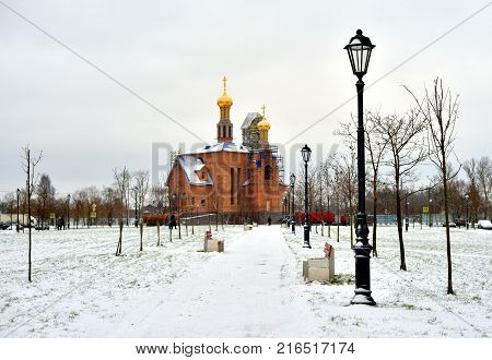 Park in Rybatskoe and the church at cloud winter day in St.Petersburg Russia.