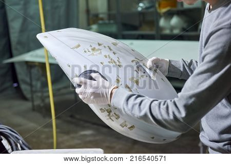 Man is polishing airplane part. Polishing aircraft detail.