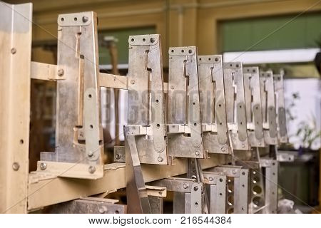 Row of identical metal details. Row of identical metal details attached to a framework.