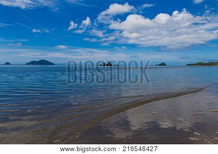 view of beachside with island on background in lio beach in philippines, El nido
