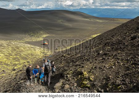 Kamchatka Peninsula, Russia - August 20, 2016: Tourists on excursions in places of Hiking trail climb to the North Breakthrough Great Tolbachik Fissure Eruption 1975