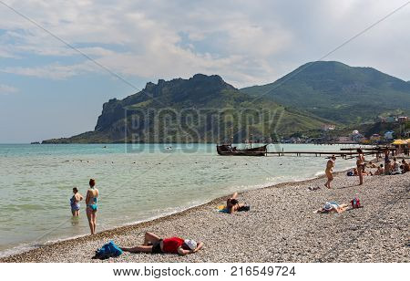 Koktebel, Russia - June 05, 2016: Pebble beach on the Black Sea in the village of Koktebel