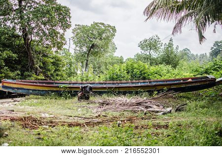 Small Fishing Boat resting broken on a beach