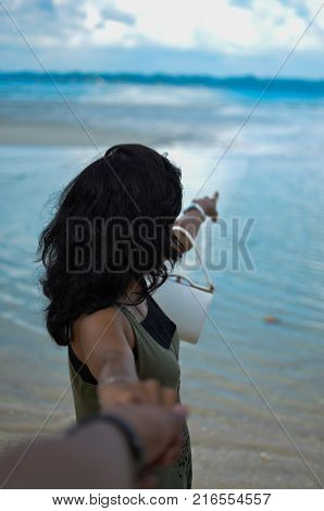 Girl Holding someones hand and pointing at something