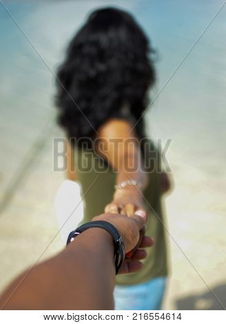 Girl Holding someones hand and pointing at something