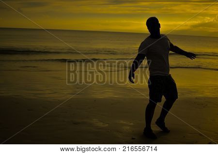 Man doing Open Arms Gesture under Setting Sun