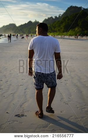 Man doing a funny walk on the beach