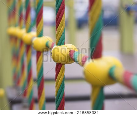 Multicolored ropes with plastic fastenings on the playground