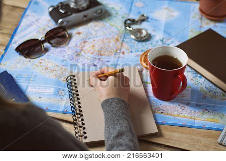 Travel Concept. Female Hand Marks The Spot On The Map. Top View