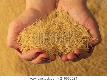 The female hands holding uncooked vermicelli close-up