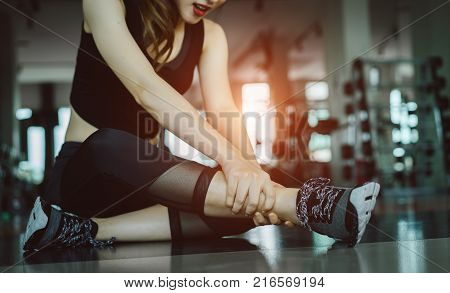 Woman doing sport exercise injury knee accident at gym fitness