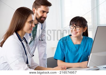 Group of doctors in the clinic discuss the diagnos of the patient