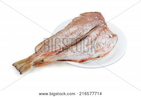 Two carcasses of uncooked red cod without heads and purified from fish scale on the white dish on a white background