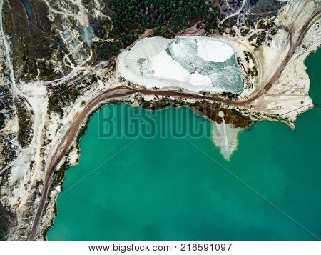 Aerial view - blue water in pond, sandy career