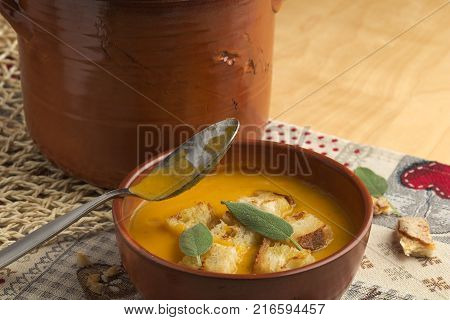 Pumpkin soup and leeks, with sage leaves.