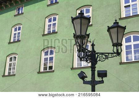 Street lamp in front of green-wall windows