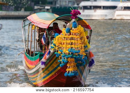 Bangkok Thailand - January 3 2016: Traditional Thai passenger boat decorated with bright flowers and garlands