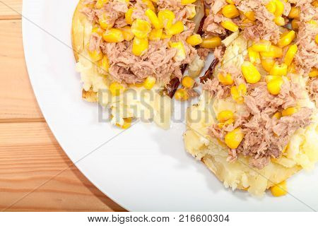 Tuna and sweetcorn topping on mashed baked potato. Healthy nutritional lunch meal. Close up from above.
