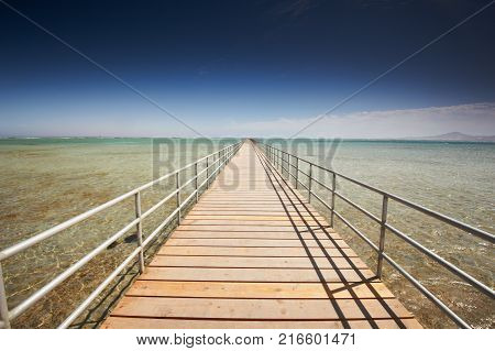 Long wooden jetty on the Red Sea. Pontoon jetty. Egypt.