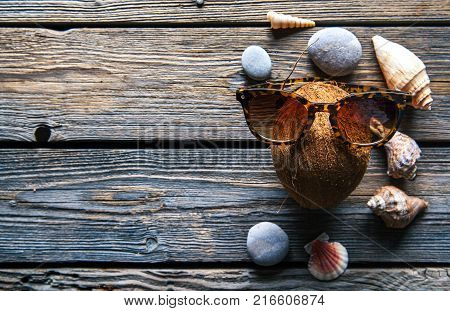 Coconut on a wooden background, seashells, stones, food, nature a