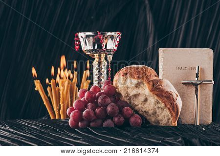 open holy bible christian cross and chalice on table Holy Communion