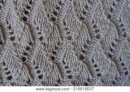 Relief pattern with perforations on handmade gray knitwork