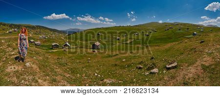 Young happy woman and High-Resolution Landscape Panorama of Adjara region of Georgia near Khulo village in Georgia