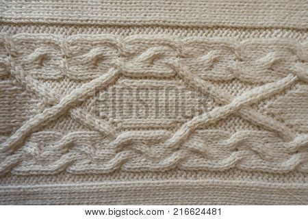 Ivory handmade knitwork with horizontal plait pattern from above