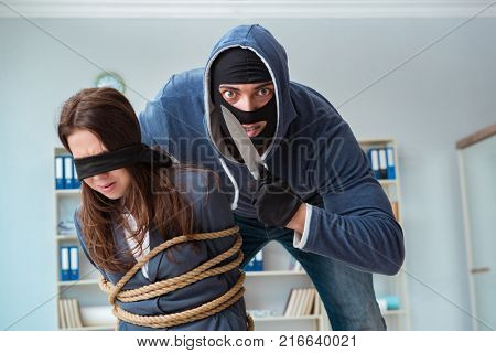 Criminal taking businesswoman as hostage in office