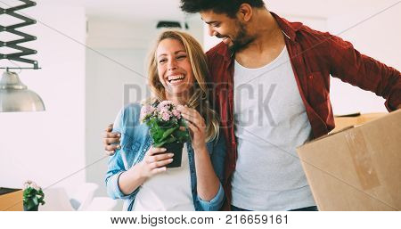 Beautiful couple happy for their new home and hugging after moving in