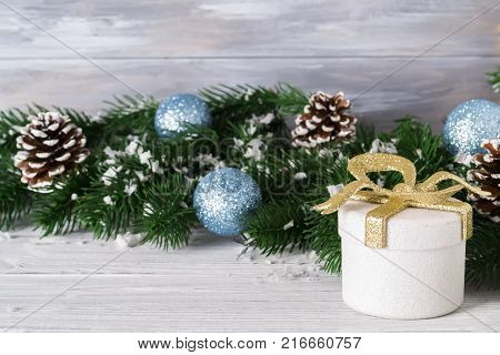 festive beautiful christmas background with gift boxes balls and christmas tree branches on white wooden background copy space