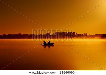 Russia Dawn on the lake. Fishermen catch fish