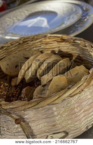 Bread in basket. Slices roll white bread and whole grain bread in the basket served on the table