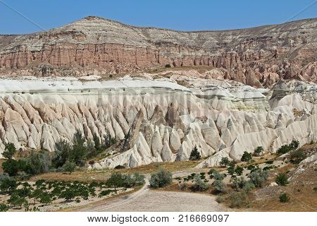 Colorful Rose valley mountain with blue sky in Cappadocia Red canyon in Goreme village Turkey. Popular tourist destination in Turkey for trekking.