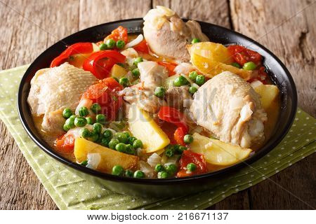 Pieces Of Chicken Stew With Potatoes, Peppers, Tomatoes, Peas And Onions Close-up. Vertical Top View