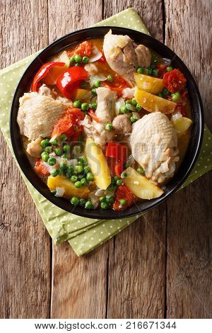 Pieces Of Chicken Stew With Potatoes, Peppers, Tomatoes, Peas And Onions Close-up. Vertical Top View