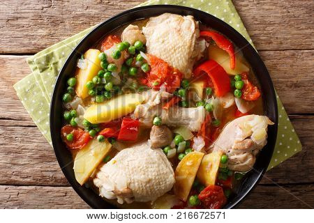 Pieces Of Chicken Stew With Potatoes, Peppers, Tomatoes, Peas And Onions Close-up. Vertical Top View