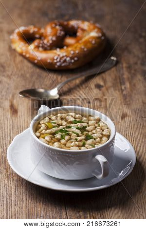portion of bavarian bratnockerl soup on wood