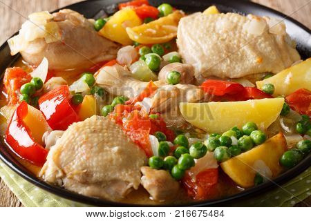 Pieces Of Chicken Stew With Potatoes, Peppers, Tomatoes, Peas And Onions Close-up. Vertical Top View