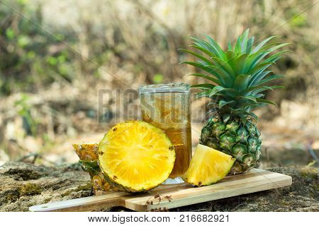 Pineapple juice in the forest.Pineapple slices put on a cutting board outside the premises.