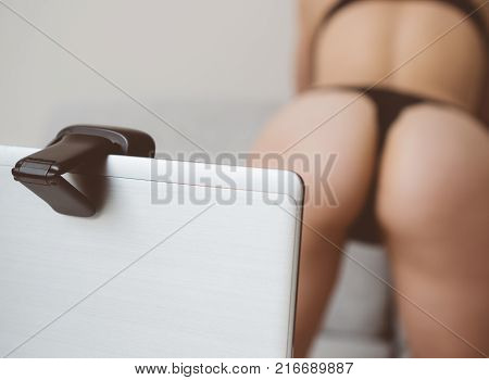 Seductive woman working as webcam model. Shows ass.