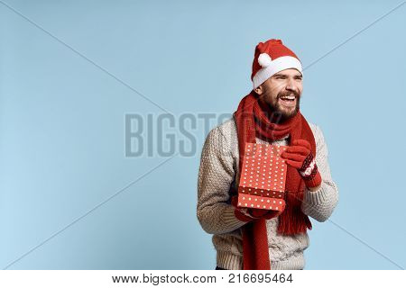 man with a gift on a light blue background, free space for copying, new year.