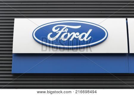 Skanderborg, Denmark - October 21, 2017: Ford logo on a wall. Ford is an American multinational automaker headquartered in Dearborn, Michigan, USA