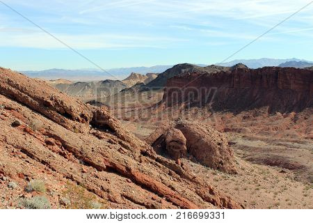 Standing atop a rocky hill viewing a mountainous landscape