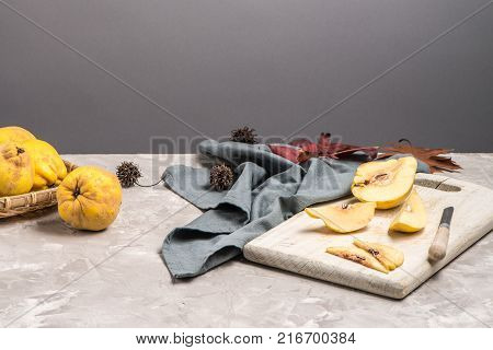 Quince fruit parts on concrete kitchen countertop.