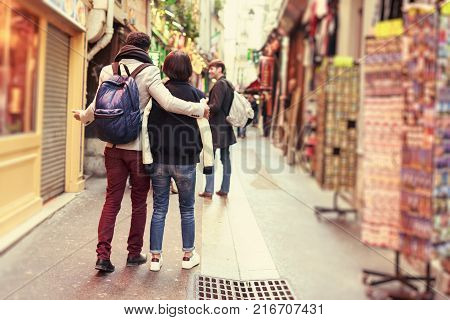Multi-ethnic group of friends having fun in Paris, Latin Quarter, near Notre Dame Cathedral.