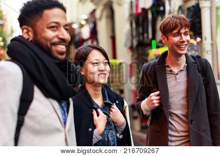 Multi-ethnic group of friends having fun in Paris, Latin Quarter, near Notre Dame Cathedral.