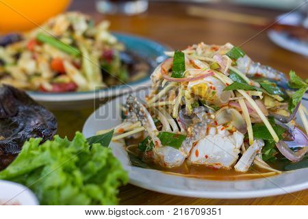 SOM-TAM Thai delicious raw papaya salad with unique taste hot and spicy this dish with tomato and crab. Papaya salad with red chili.